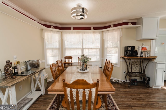 dining room featuring dark wood-style floors, a notable chandelier, a textured ceiling, and baseboards