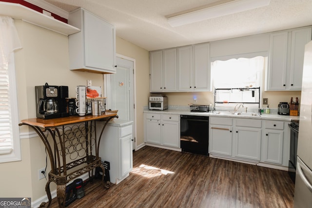 kitchen featuring dark wood-type flooring, a sink, plenty of natural light, light countertops, and dishwasher