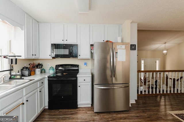 kitchen with a sink, black appliances, light countertops, dark wood-type flooring, and white cabinetry