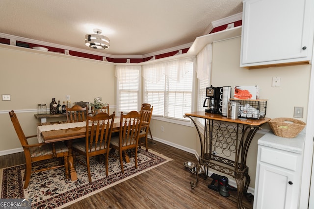 dining space featuring baseboards, a textured ceiling, dark wood finished floors, and ornamental molding