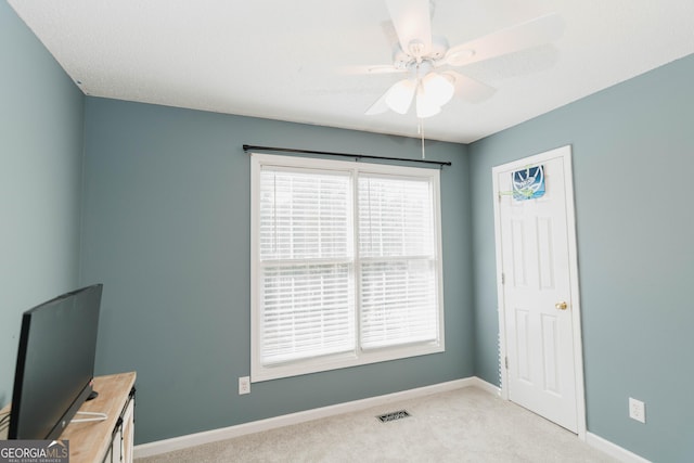 interior space featuring visible vents, ceiling fan, and baseboards