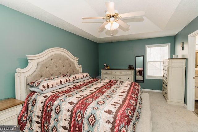 bedroom with light colored carpet, a ceiling fan, and baseboards