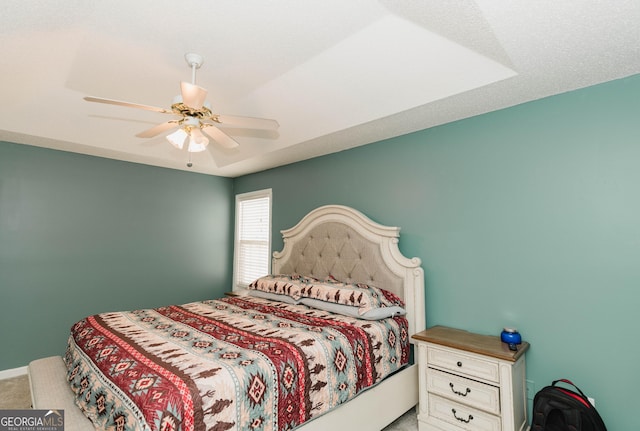 bedroom featuring a ceiling fan and carpet