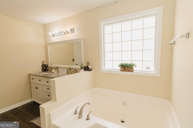 31 Wyngate Ct, Dallas, GA 30157 - bathroom with a sink, wood finished floors, a bath, baseboards, and double vanity