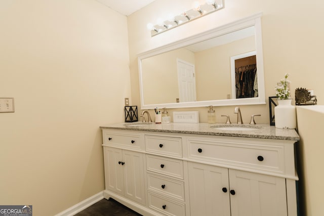 31 Wyngate Ct, Dallas, GA 30157 - bathroom featuring baseboards, double vanity, a sink, and wood finished floors