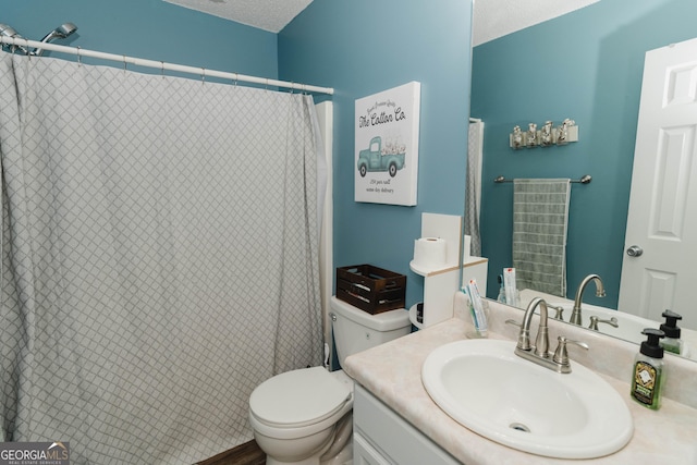 full bathroom featuring a textured ceiling, vanity, and toilet