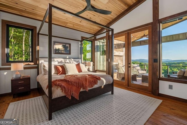 bedroom with wood finished floors, lofted ceiling, wooden ceiling, and access to exterior