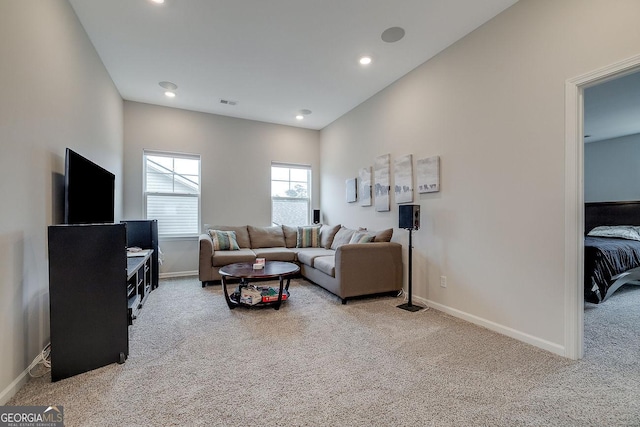 living area featuring visible vents, recessed lighting, baseboards, and carpet