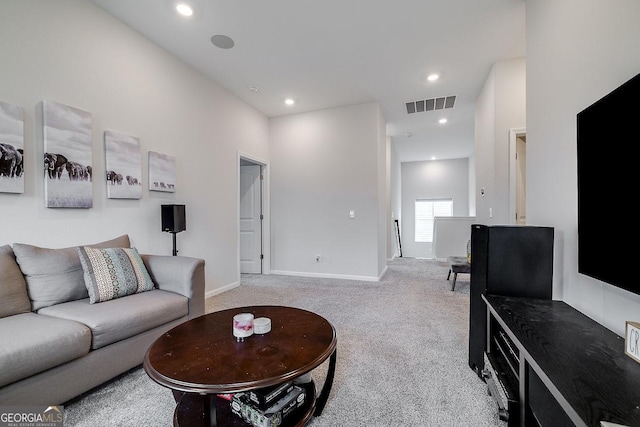 carpeted living room with recessed lighting, visible vents, and baseboards