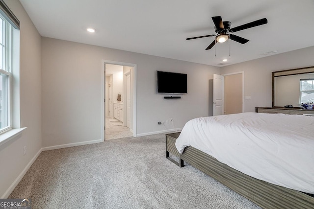 carpeted bedroom featuring a ceiling fan, visible vents, baseboards, recessed lighting, and ensuite bathroom