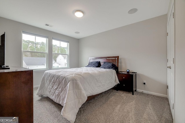 carpeted bedroom featuring visible vents and baseboards