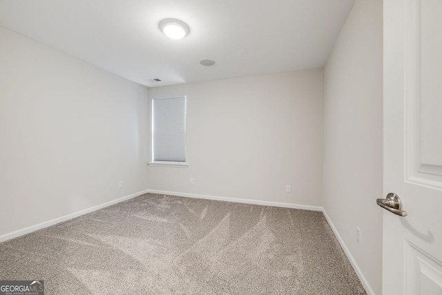 spare room with visible vents, baseboards, and carpet floors