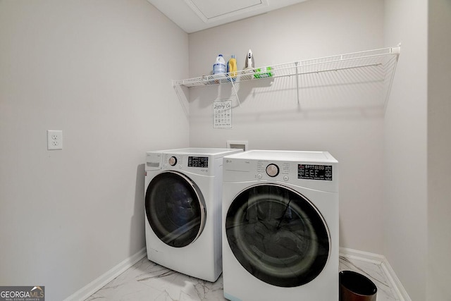 clothes washing area with baseboards, marble finish floor, laundry area, and washer and clothes dryer