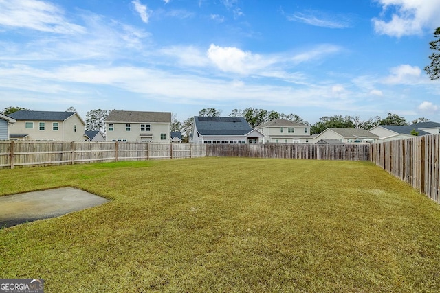 view of yard with a residential view and a fenced backyard