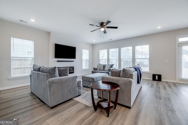 living area featuring recessed lighting, light wood-style floors, visible vents, and baseboards