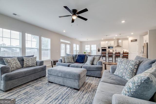 living room with wood finished floors, recessed lighting, visible vents, and ceiling fan