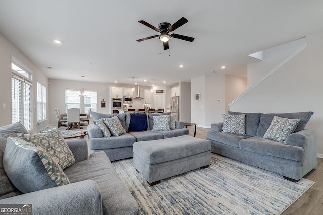 living room featuring light wood-style flooring, recessed lighting, baseboards, and ceiling fan