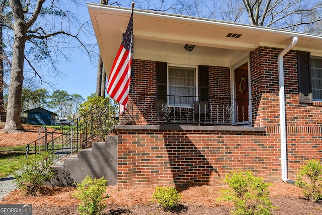 view of front of home featuring fence and brick siding