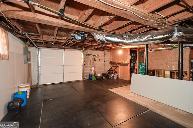 garage featuring electric panel and a garage door opener