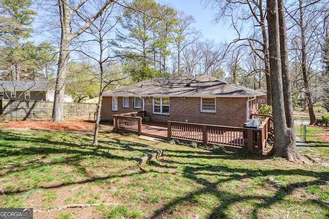 2780 Eastfield Rd SE, Smyrna, GA 30080 - rear view of house with brick siding, fence, a wooden deck, and a yard
