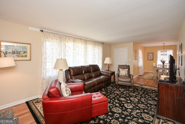 living area with wood finished floors and baseboards