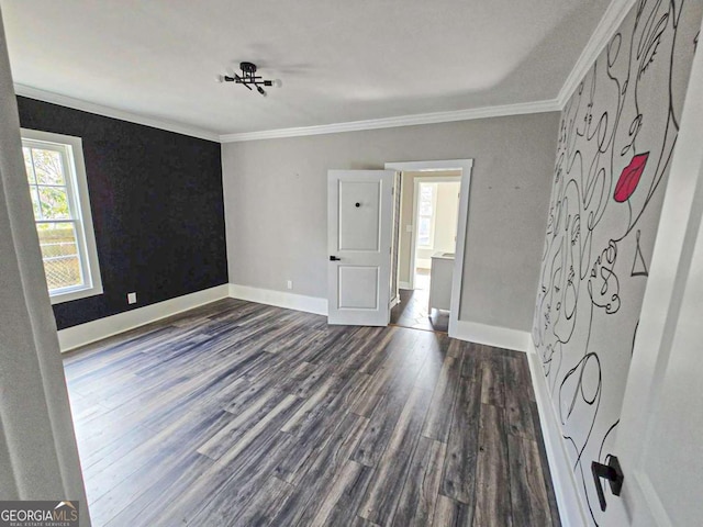 unfurnished bedroom with dark wood-style flooring, baseboards, and ornamental molding