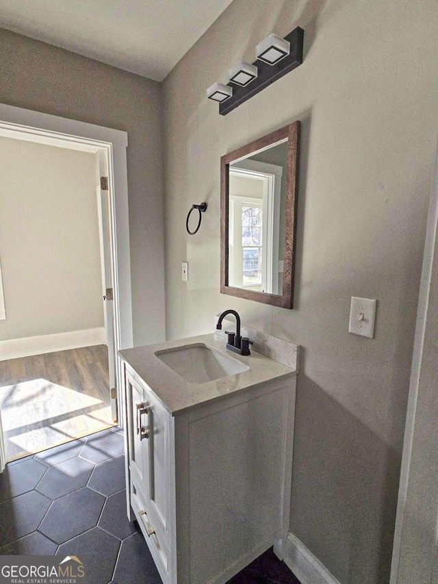 bathroom featuring vanity and baseboards