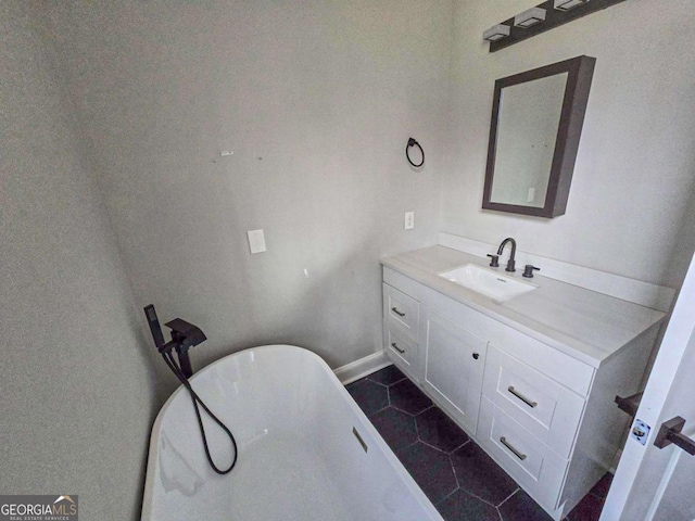 full bath with a soaking tub, vanity, and tile patterned flooring