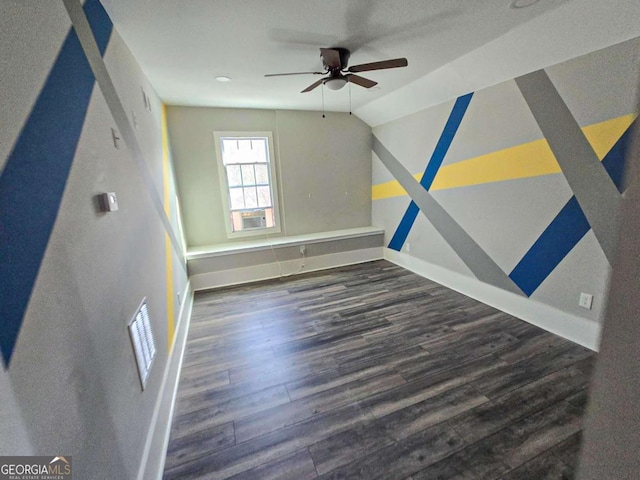 interior space with visible vents, baseboards, lofted ceiling, wood finished floors, and a ceiling fan