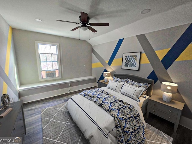 bedroom with baseboards, lofted ceiling, and wood finished floors