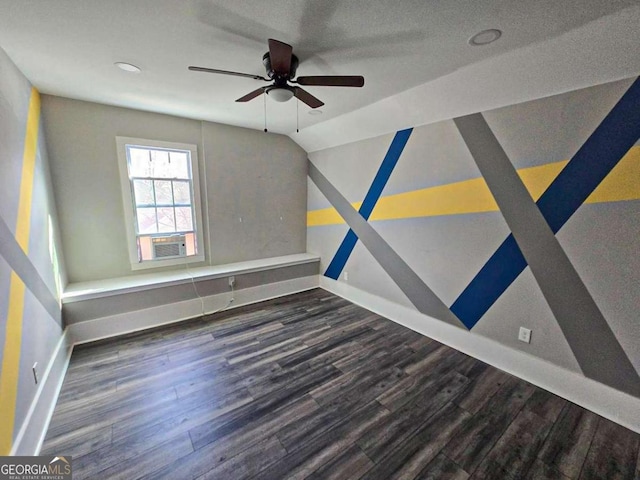 unfurnished bedroom featuring lofted ceiling, wood finished floors, and baseboards