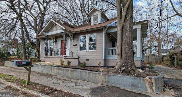 view of front of house with crawl space and fence