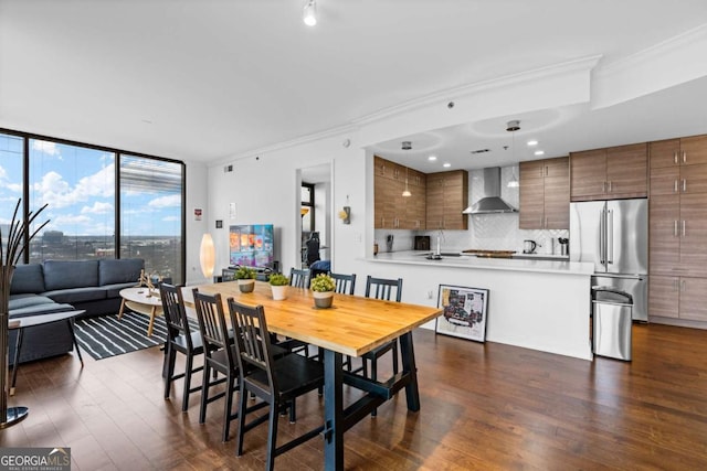 dining room featuring floor to ceiling windows, crown molding, and dark wood-type flooring