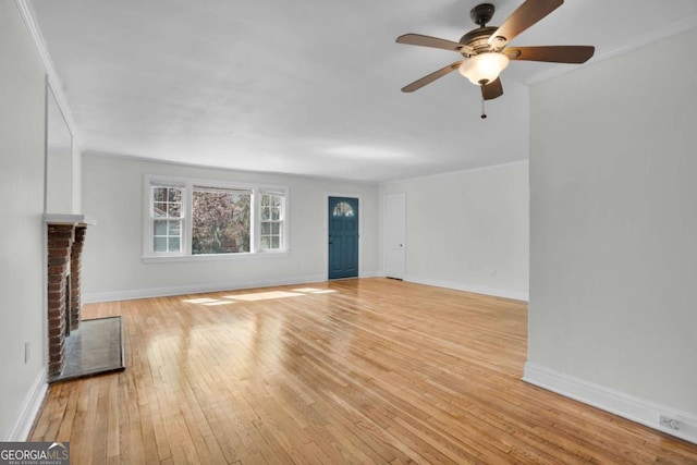 unfurnished living room featuring a fireplace, baseboards, and wood-type flooring