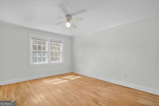 unfurnished room with crown molding, light wood-style flooring, baseboards, and ceiling fan