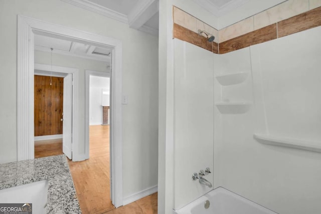 full bathroom featuring shower / washtub combination, crown molding, baseboards, and wood finished floors