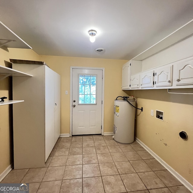 washroom featuring visible vents, washer hookup, electric water heater, cabinet space, and light tile patterned floors