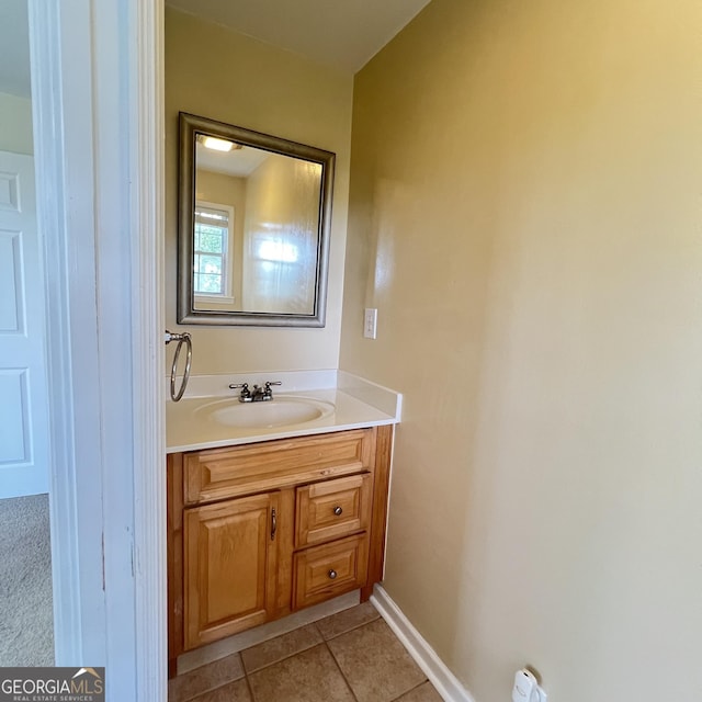 bathroom featuring baseboards, vanity, and tile patterned flooring