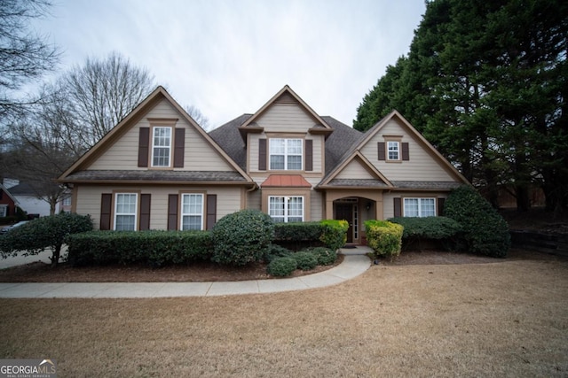 craftsman house featuring roof with shingles