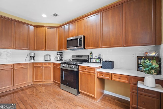 kitchen with visible vents, stainless steel appliances, and light countertops