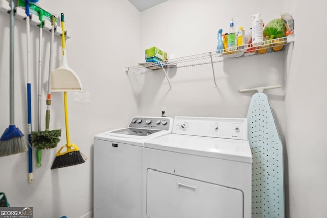 washroom with washing machine and dryer and laundry area