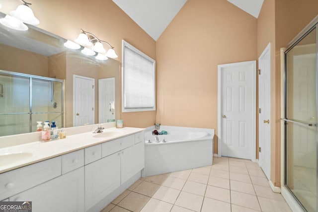 bathroom with tile patterned floors, a stall shower, a sink, double vanity, and lofted ceiling