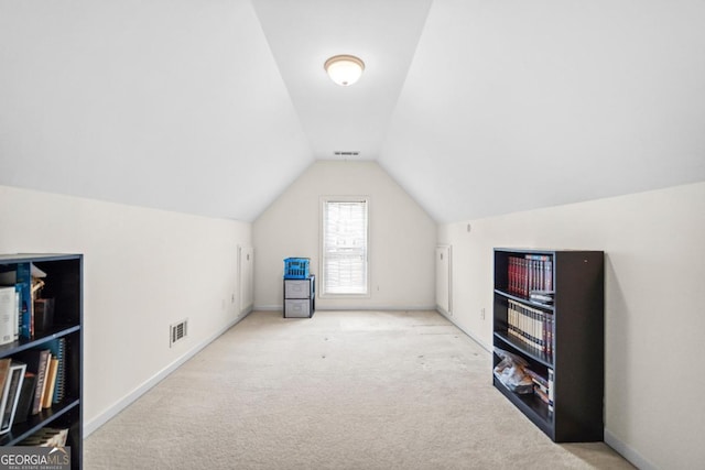 bonus room featuring visible vents, carpet flooring, and vaulted ceiling