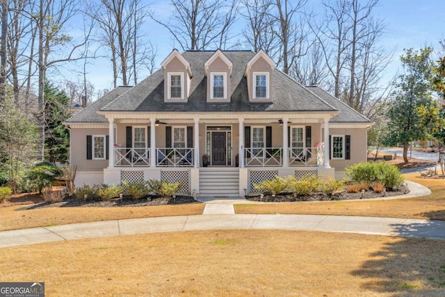 view of front of home with stucco siding, a porch, a ceiling fan, and a shingled roof