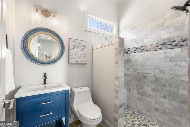full bath featuring vanity, toilet, and a tile shower