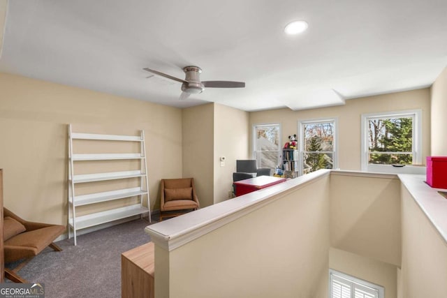 interior space featuring an upstairs landing, recessed lighting, a ceiling fan, and carpet