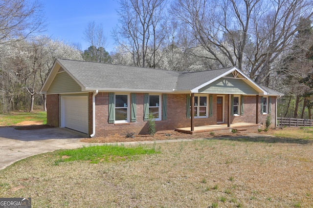 single story home featuring driveway, fence, covered porch, a garage, and brick siding