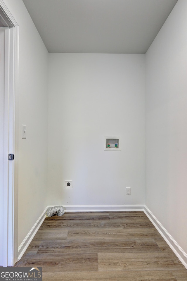 laundry room featuring electric dryer hookup, washer hookup, wood finished floors, baseboards, and laundry area