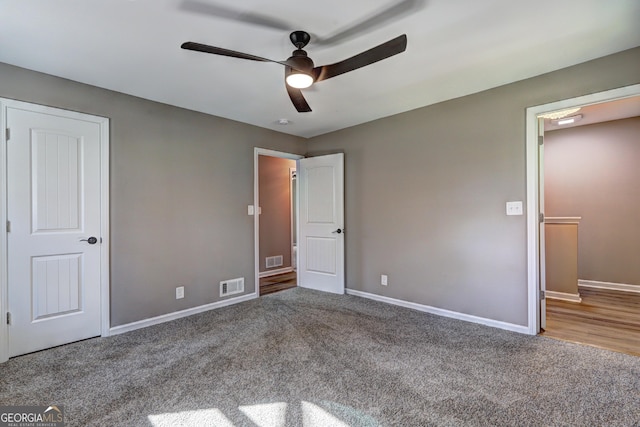 unfurnished bedroom featuring visible vents, carpet floors, and baseboards