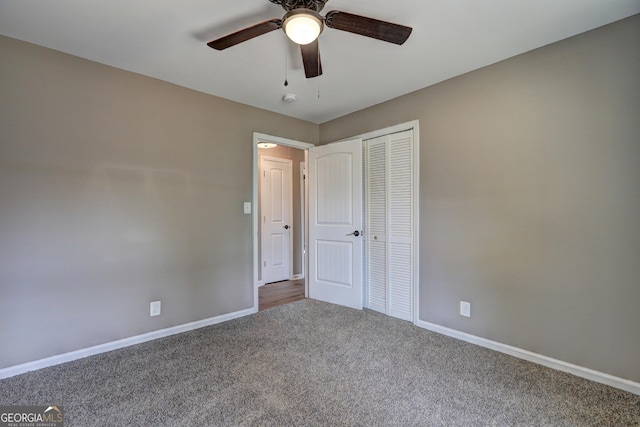 unfurnished bedroom with a ceiling fan, carpet, baseboards, and a closet